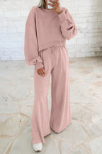 Light pink drop shoulder crop pullover with drawstring wide leg pants set in soft polyester cotton blend