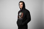Man wearing Buckhaus black hoodie with cracked flaming skull design and front pouch pocket