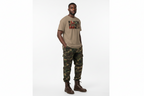Black History Month unisex classic tee in tan with bold print worn with camouflage cargo pants and brown boots