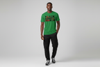 Male model wearing green Black History Month unisex classic tee with black cargo pants and sneakers