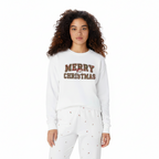 Woman wearing white Merry Christmas unisex sweatshirt and matching white pajama pants with small holiday prints