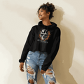 Woman wearing black cropped hoodie with cracked flaming skull graphic and raw hem paired with ripped jeans